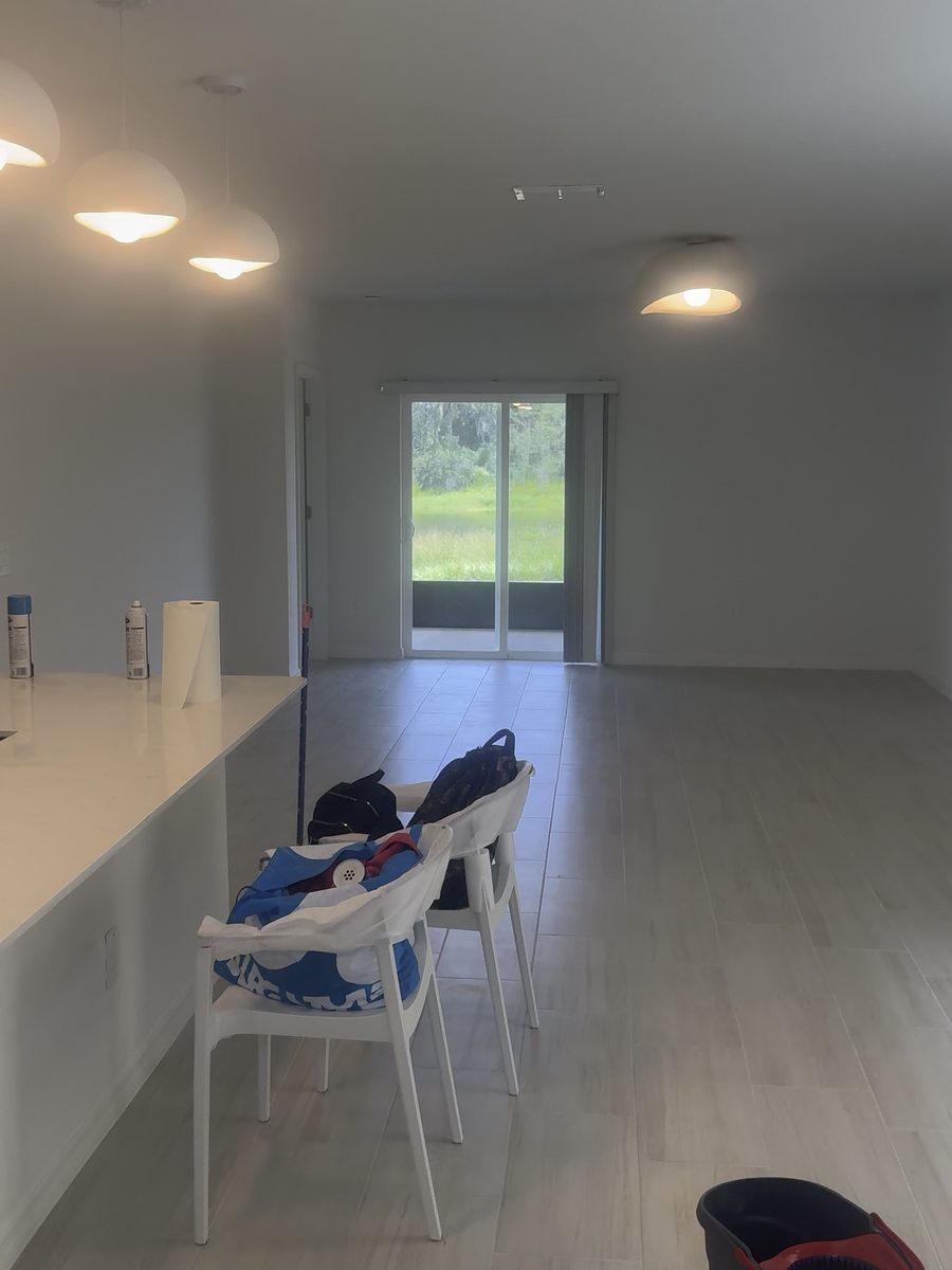 Freshly mopped great room and kitchen bar with a mop bucket, finished house cleaning job by Pure Perfection Cleaning, Tampa, FL