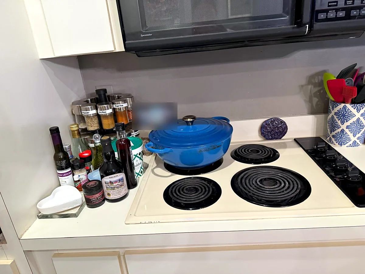 Same stovetop wiped clean and reset after a Pure Perfection house cleaning